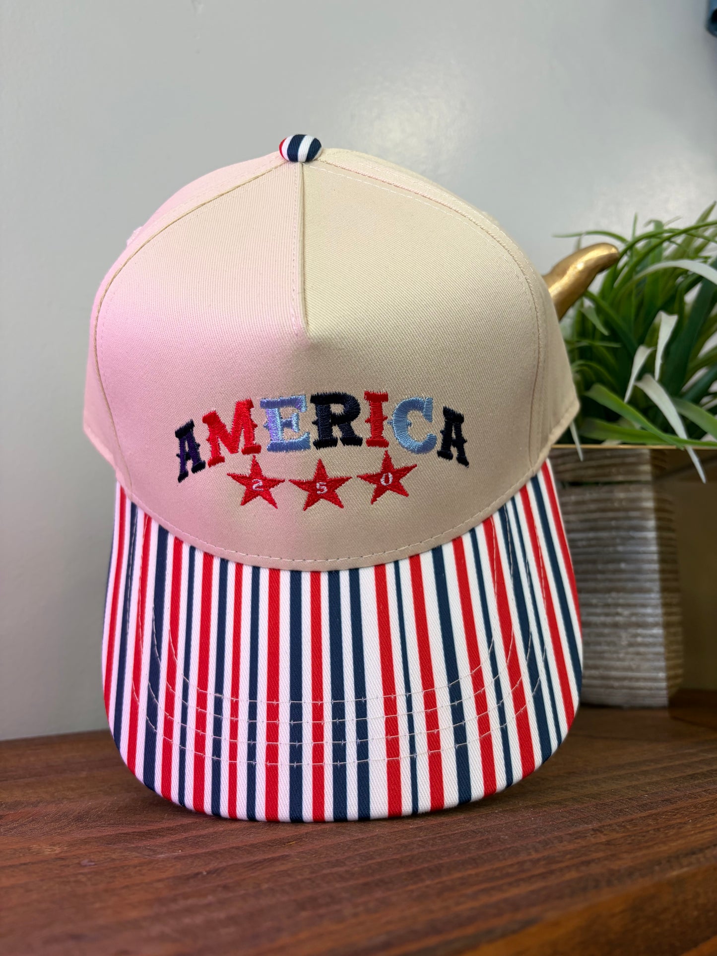 Stripe bill embroidered America 250 hat.